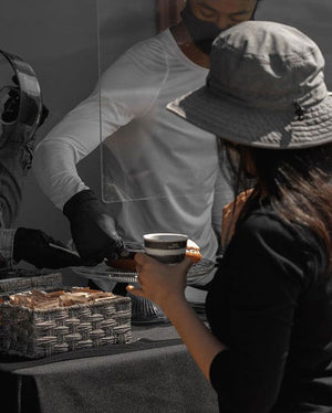 A women grabbing coffee and doughnuts at a specialty coffee pop up event in Los Angeles, CA. Hosted by Black Stallion Coffee roaster in San Gabriel, Ca. 